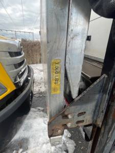 Truck hitch area of a 2016 Hino 268 with a yellow label and metal latch visible in the cargo area.