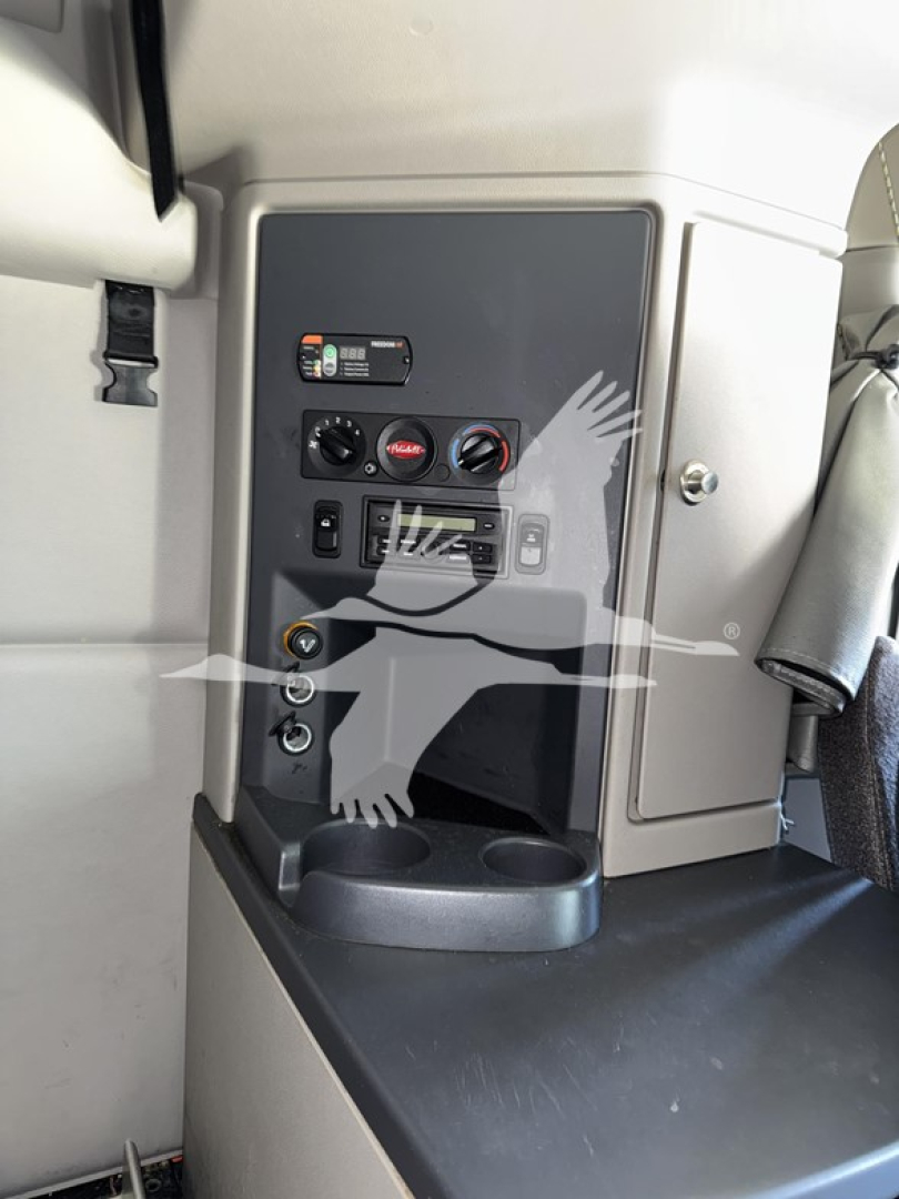 Controls panel in Peterbilt 579 cab with gauge dials, switches, and cup holder area visible.