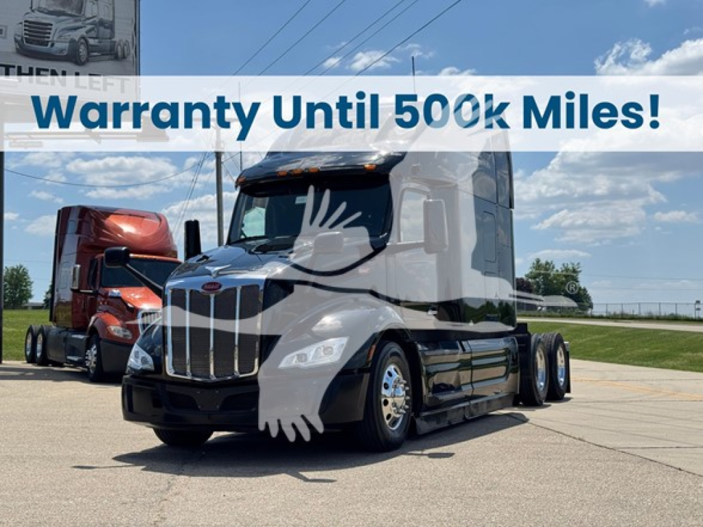 Peterbilt 579 truck in a showroom lot with a white overlay banner that reads Warranty Until 500k Miles.