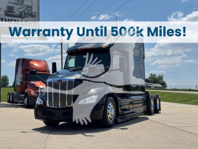 Peterbilt 579 truck in a showroom lot with a white overlay banner that reads Warranty Until 500k Miles.
