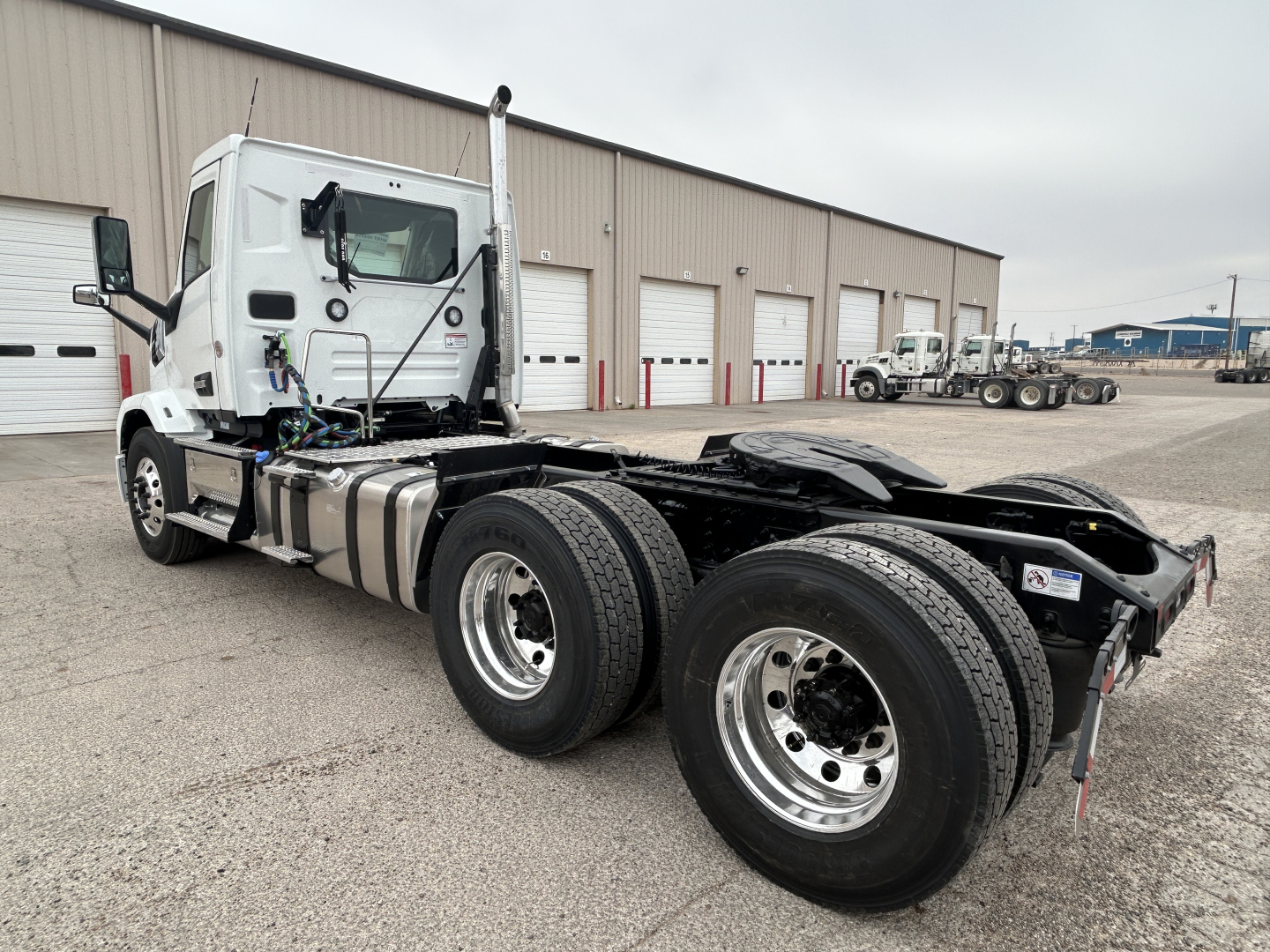 Mack AN64T truck chassis side view showing 6-wheel configuration and cab with visible hood, fuel tanks, and rear chassis.