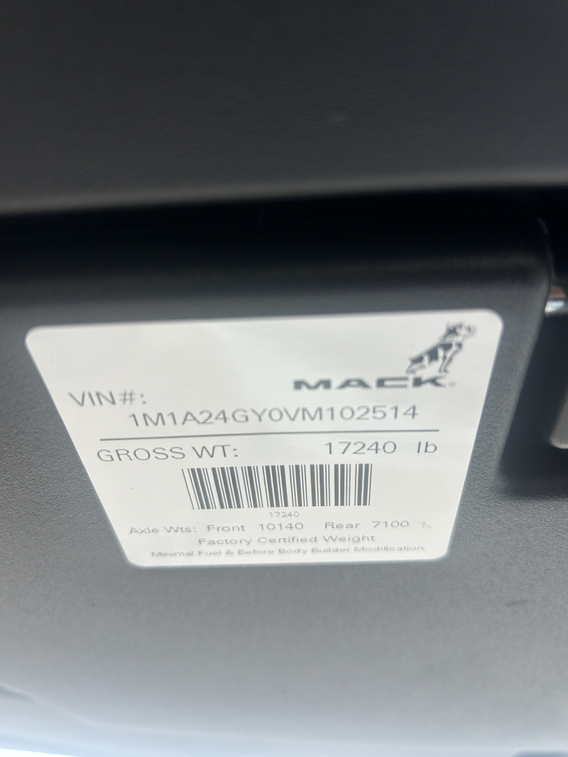 Mack AN64T VIN label showing VIN 1M1A24GY0VM102514 and gross weight 17240 lb mounted on interior/door area.