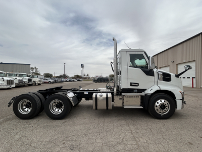 Side view of a 2027 Mack AN64T conventional daycab truck showing chassis and cab with fuel tanks and exhaust stack.