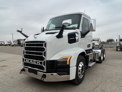 Truck front-left view of a white 2027 Mack AN64T conventional daycab with large grille, dual side mirrors, and amber turn signals.