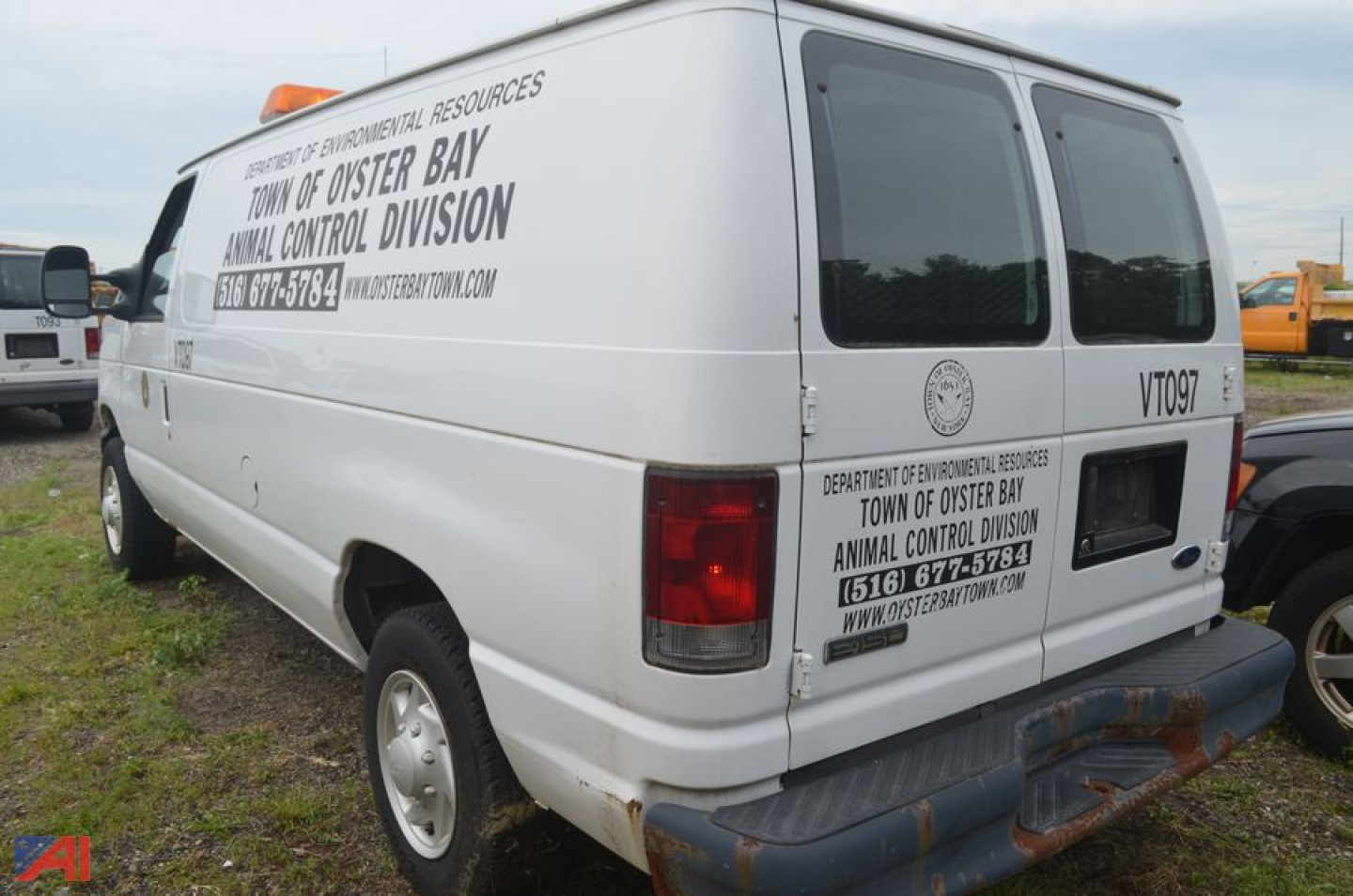 Ford Econoline cargo van rear side view with text labels on doors and windows, signage for Town of Oyster Bay Animal Control Division.