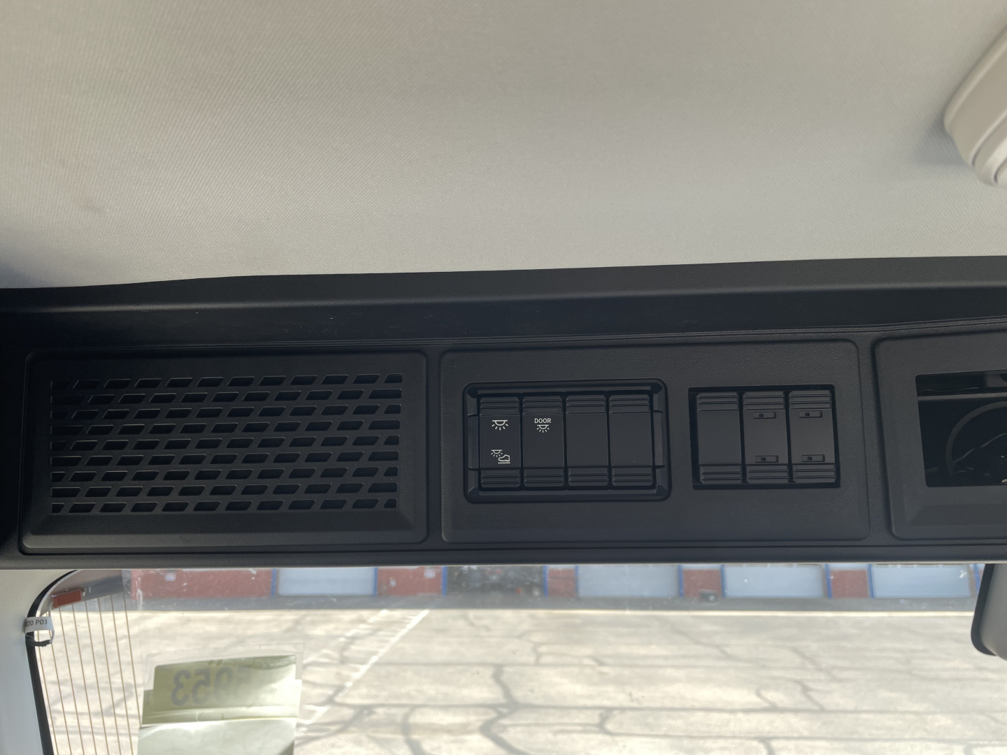 Mack AN64T truck dash area showing switch panel and vent grille.