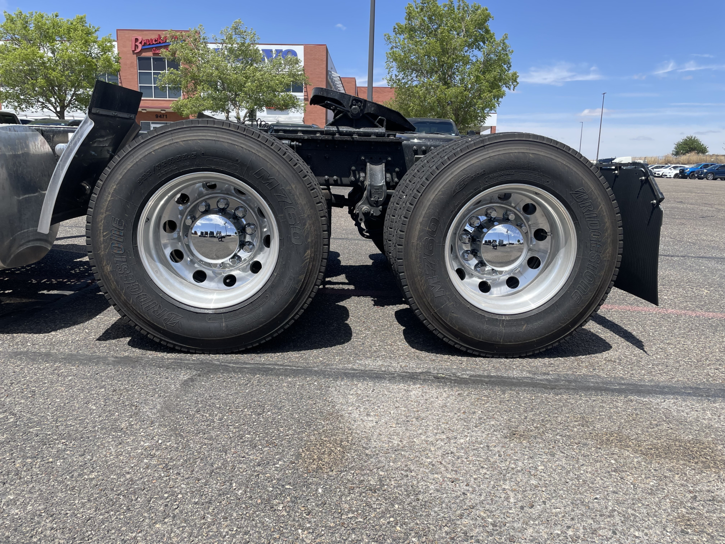 Mack AN64T truck chassis showing dual rear wheels and wheel hubs with polished rims.