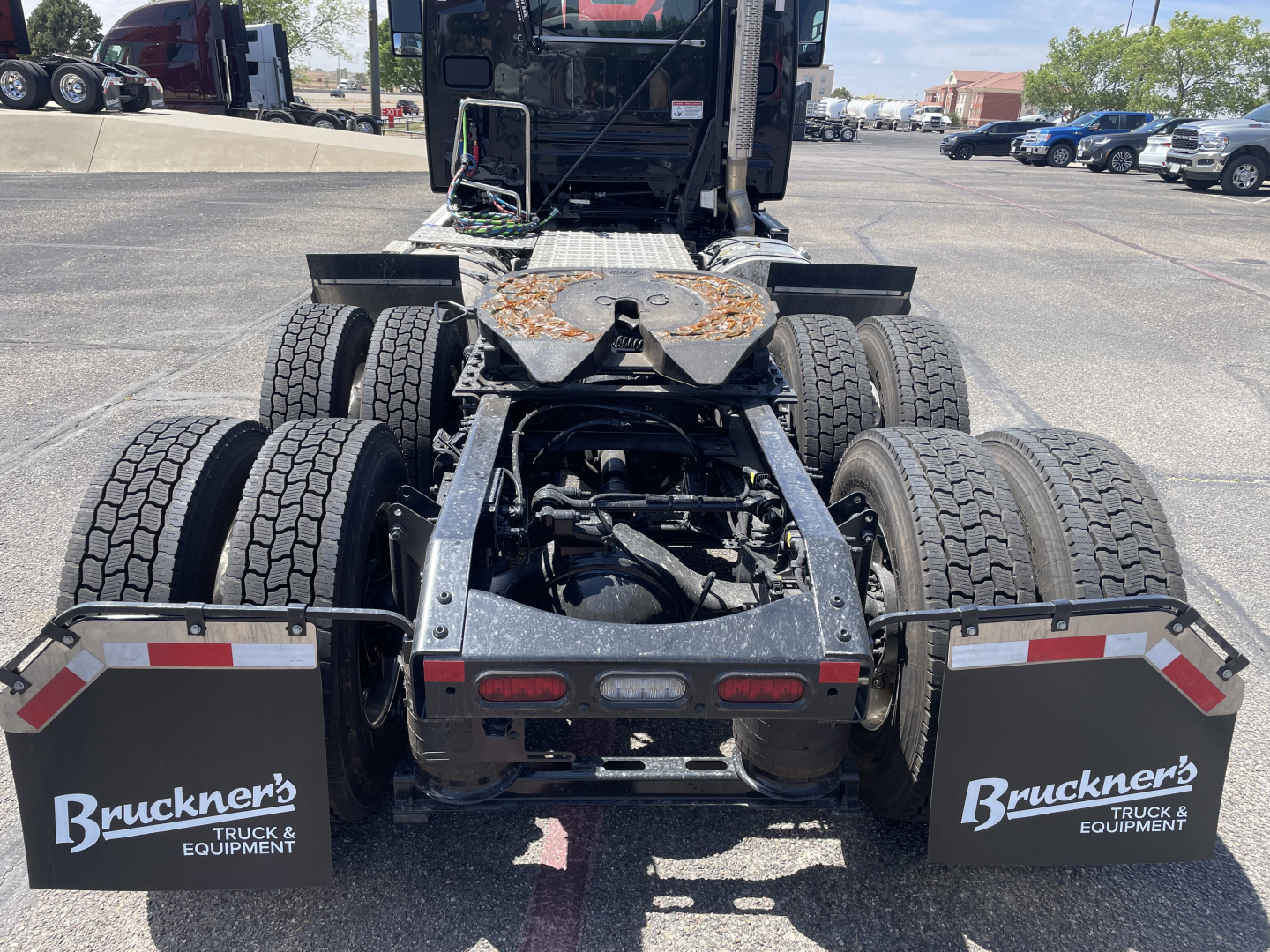 Mack AN64T conventional daycab rear view showing dual rear axle setup, fifth wheel, mud flaps with Bruckner's Truck & Equipment logos, and chassis components.