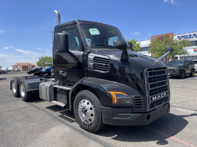 New 2027 Mack AN64T conventional daycab semi-truck in black, front three-quarter view, with dual rear axles and exhaust stacks.