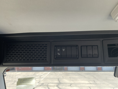 Mack AN64T truck dash area showing switch panel and vent grille.