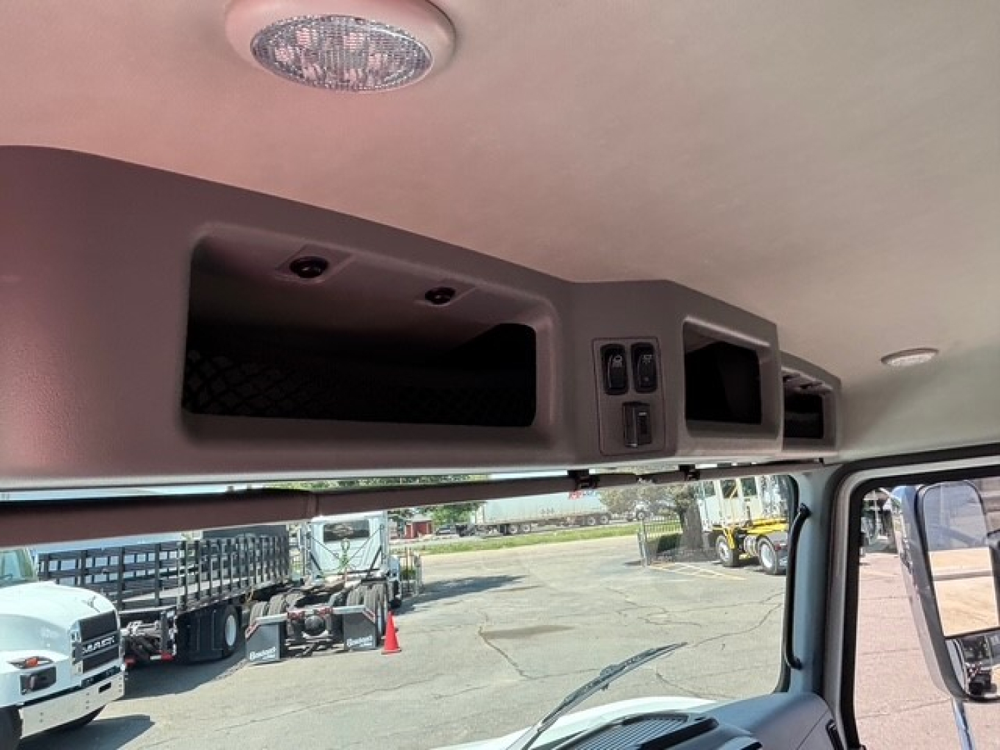 Mack MD7 cabin interior overhead panel showing storage compartments and controls.