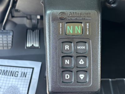 Mack MD7 truck cab interior showing Allison Transmission shifter with NN mode and gear buttons R, N, D, Mode, +/-, and selector lever area.