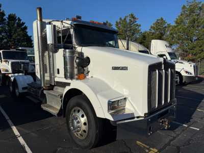 Kenworth T800 conventional sleeper truck in white, front view, with chrome grille and dual exhaust stacks.