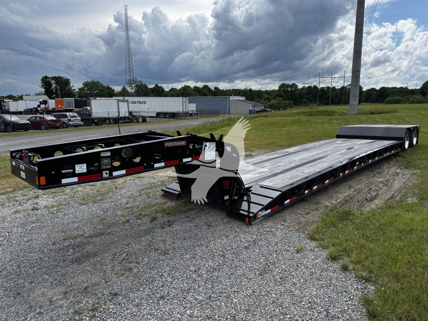 Fontaine N20 lowboy trailer showing long multi-axle deck with black frame and silver deck, VIN tag and stock number visible.