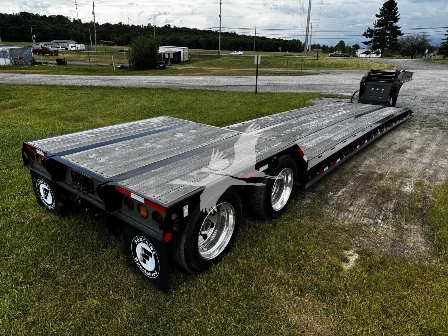 Fontaine N20 lowboy trailer in a parking area showing long aluminum deck, triple axle, and rear ramps. Stock number T35A5590 with VIN 13N350209T35A5590 visible.