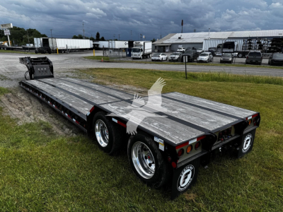 Heavy open flatbed trailer showing dual rear axles and aluminum deck with Fontaine N20 branding.