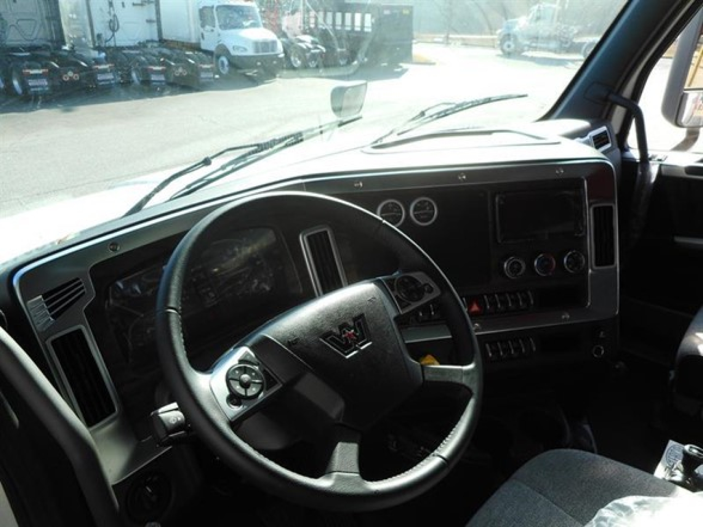 Interior of a 2026 Western Star 47X truck cab showing steering wheel dashboard and instrument cluster.