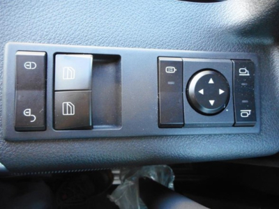Interior door panel switches showing window controls and joystick-style mirror adjustment on a Western Star 47X truck.