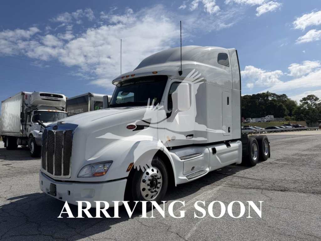 Peterbilt 579 conventional sleeper tractor in white, 6x4 with aerodynamic cab, chrome grille, dual rear axles, in-service truck with ‘ARRIVING SOON’ overlay.