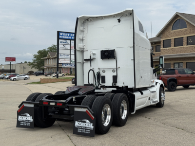 Peterbilt 579 rear view showing tractor with solebar and sleeper cab, twin rear axles, white chassis, no trailer attached.