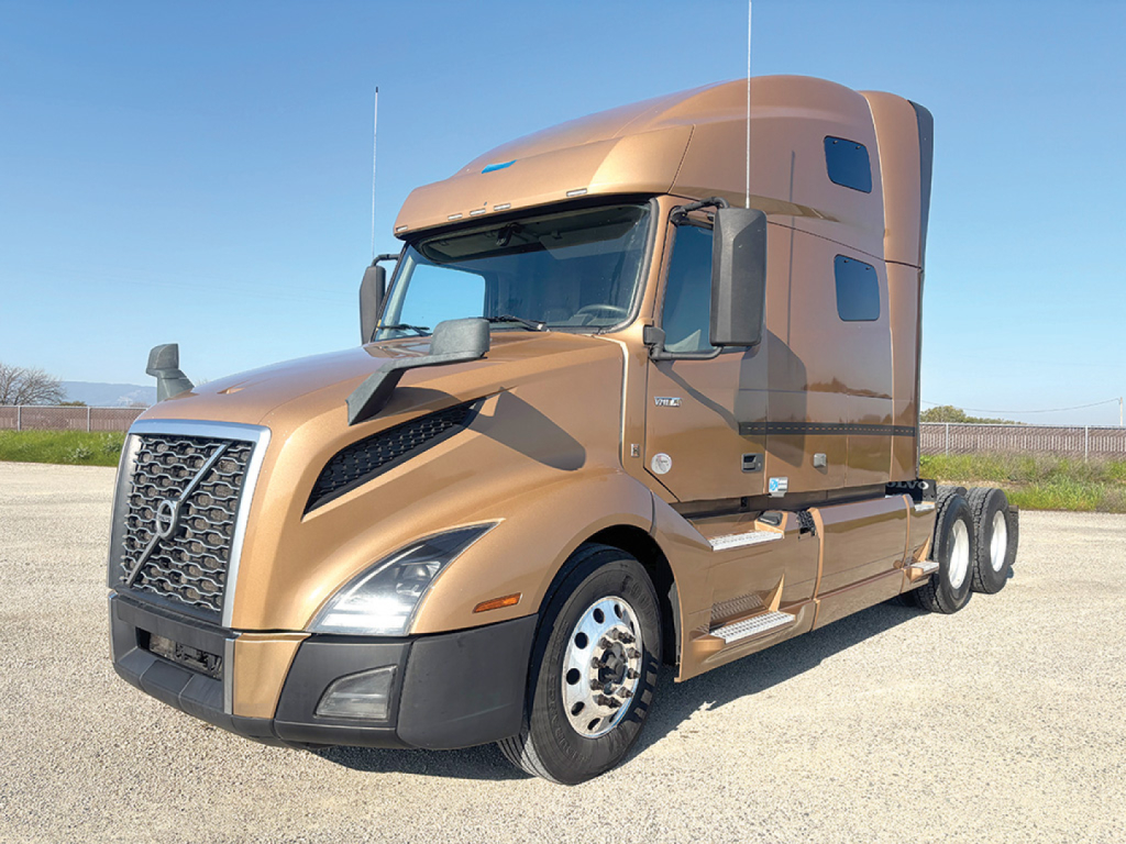 Volvo VNL 760 sleeper cab with tan color, front left view showing grille, headlights, and dual rear axles.
