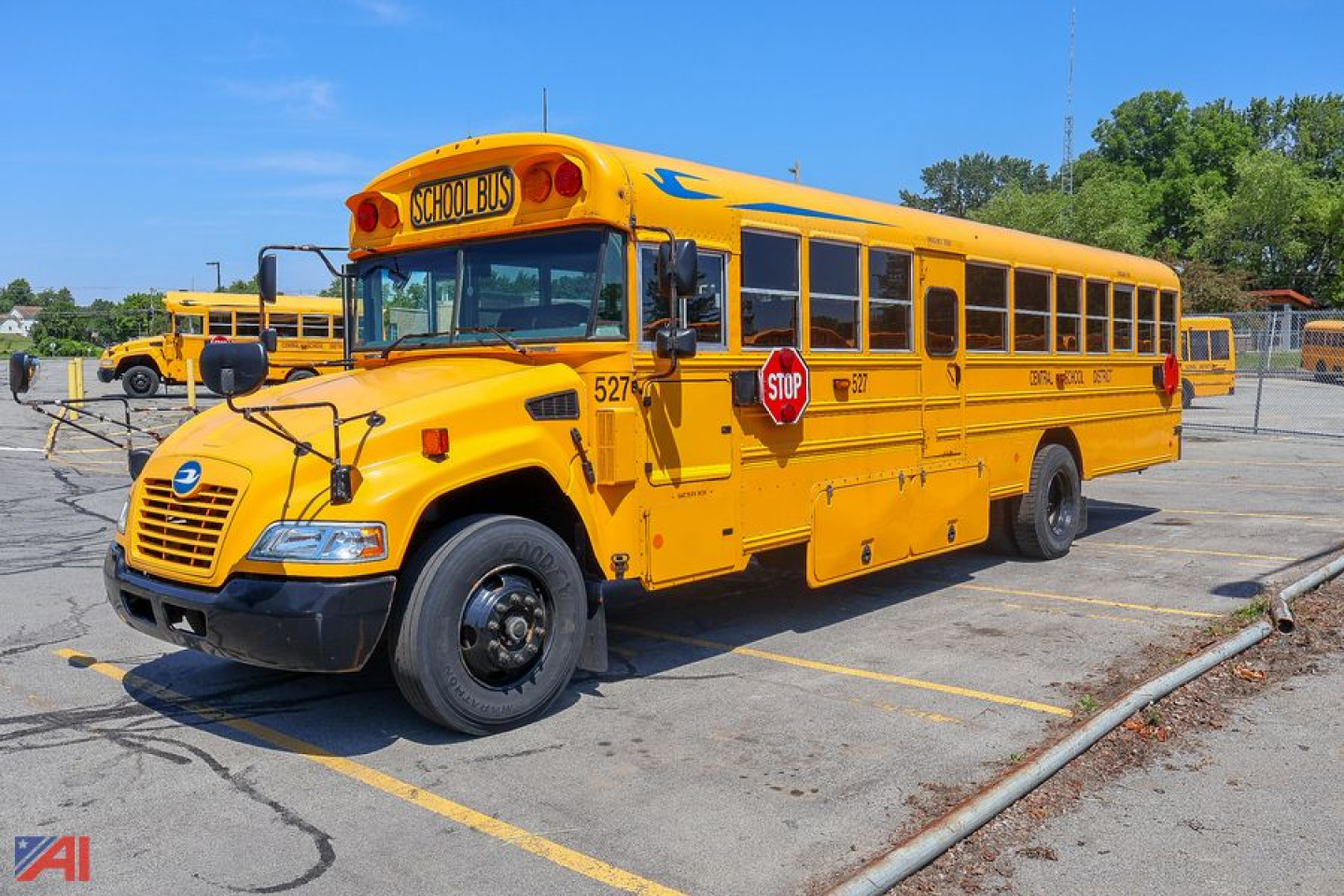 School bus showing front and side view; yellow 2018 Blue Bird Vision school bus with stop sign and school bus markings.