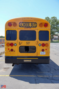 Rear view of a yellow 2018 Blue Bird Vision school bus with a blue 'SCHOOL BUS' sign, taillights, and numbered 527.