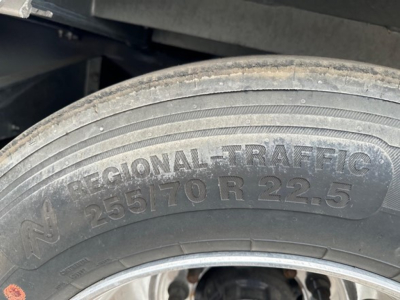 Truck trailer wheel close-up showing tire markings 'REGIONAL TRAFFIC 255/70 R 22.5' on the sidewall.