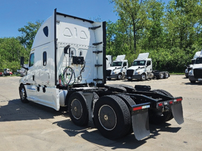 Fleet truck cab and chassis at rear view with Freightliner Cascadia sleeper, white, VIN plate area not visible, cargo trailer hitch and dual rear axles.