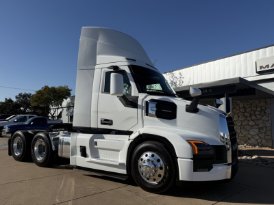 Truck image showing a white 2026 Mack PR64T conventional daycab with a tall sleeper, chrome wheels, and cab details.