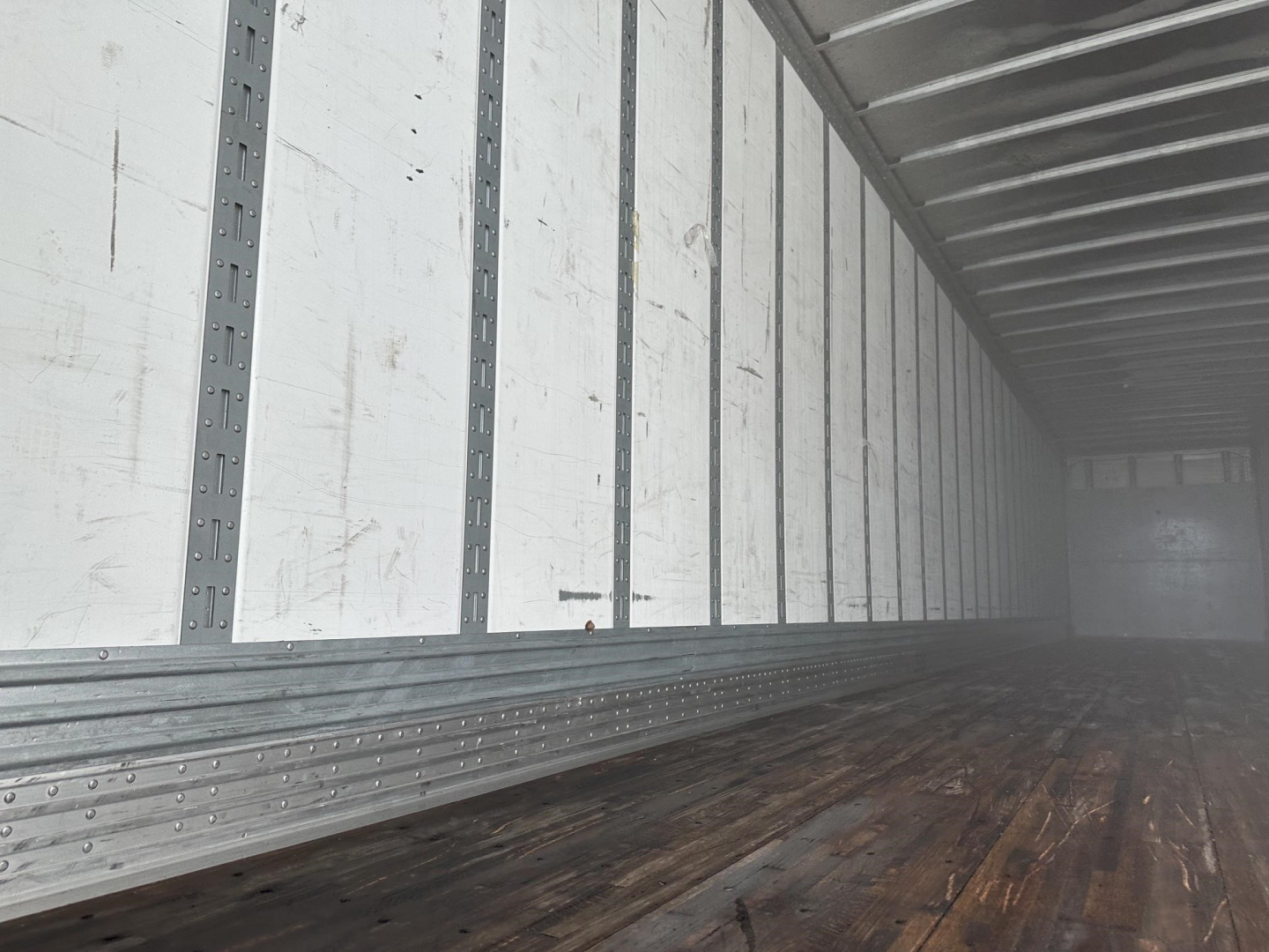 Interior of a Hyundai dry van trailer cargo area with aluminum floor rails and ribbed walls; no additional visible labels or numbers.