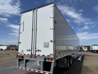Hyundai air ride dry van trailer with rear swing doors and aluminum roof, side view showing back doors and reflective trim.