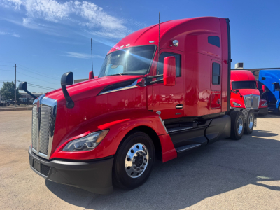 Kenworth T680 conventional sleeper truck in red, front-left view, with chrome grille and dual rear axles visible.