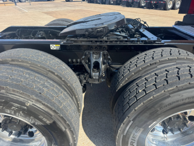 Kenworth T680 chassis cab showing dual rear axles and fifth wheel mounting with fuel and air lines visible.
