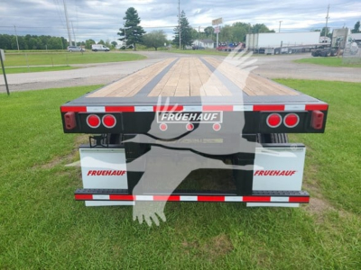 Fruehauf steel flatbed trailer rear showing FRUEHAUF branding and rear lights