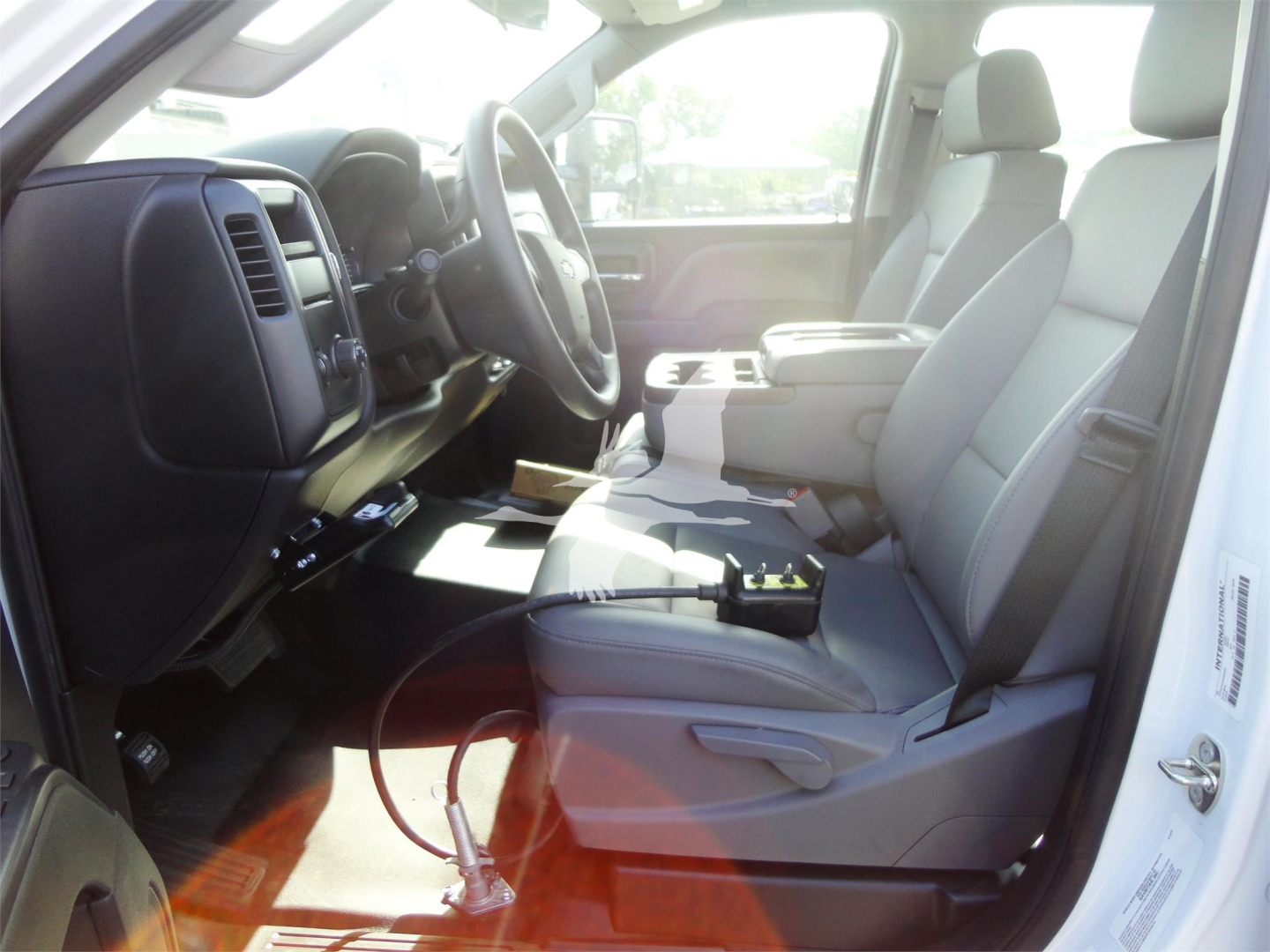 Chevrolet Silverado 5500HD interior showing front seats and dashboard with center console and steering wheel