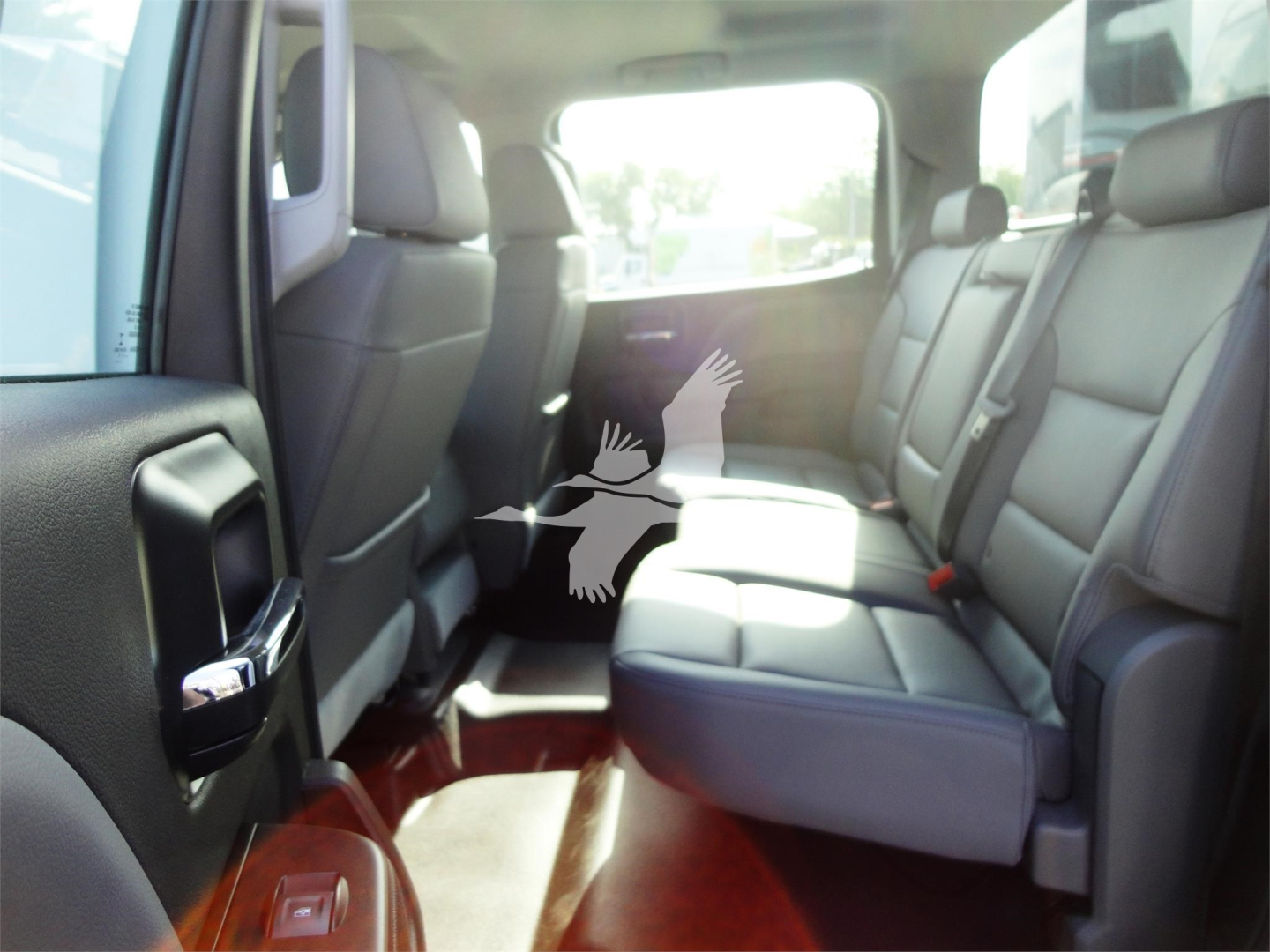 Chevrolet Silverado 5500HD interior view of rear seating showing gray leather seats and spacious cabin.