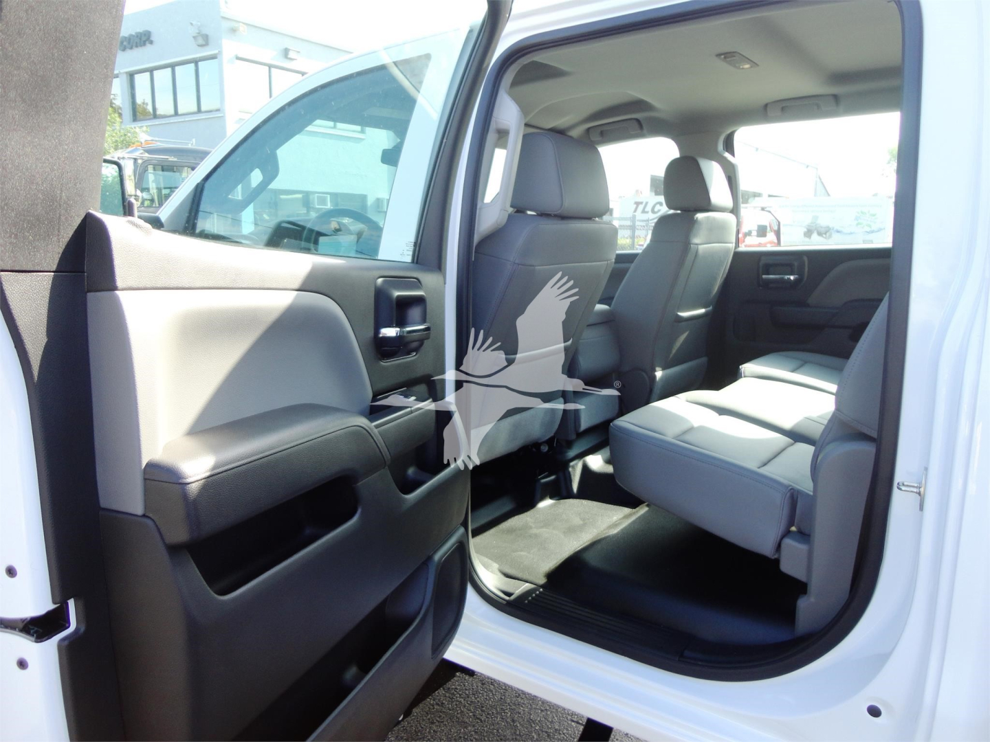Chevrolet Silverado 5500HD truck interior view with front passenger seat and open rear door.