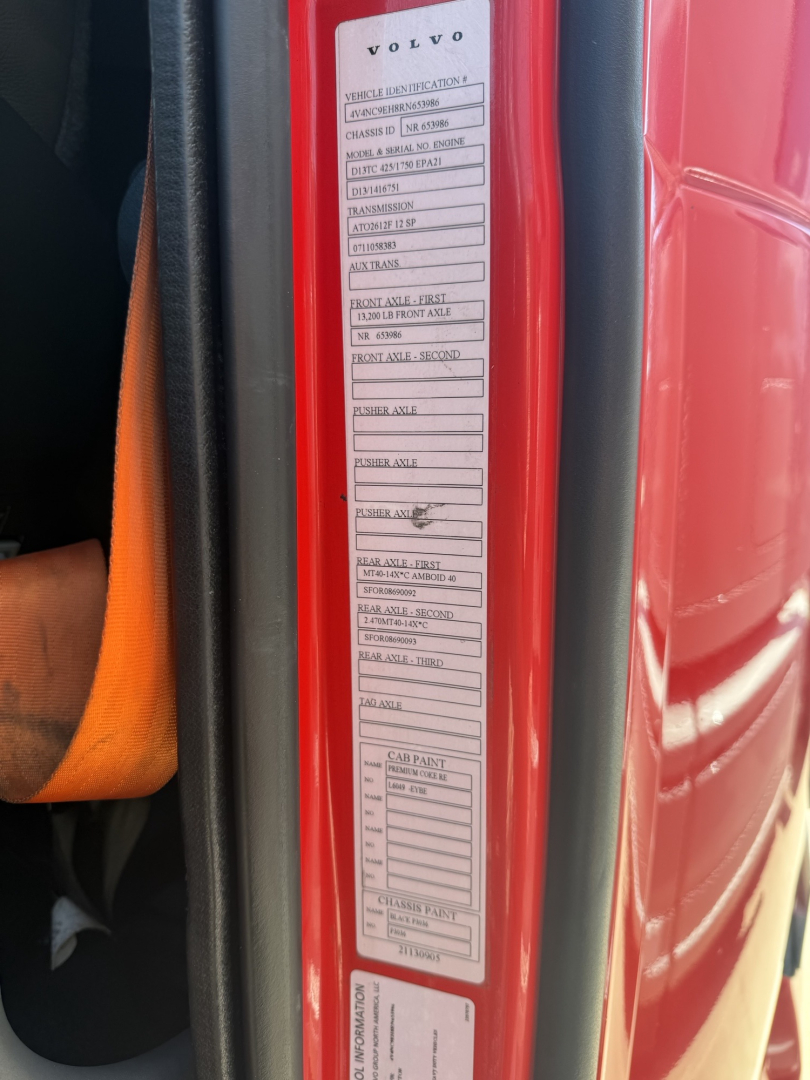 Volvo truck door jamb label showing vehicle specifications and warning stickers visible in a red Volvo VNL exterior edge.
