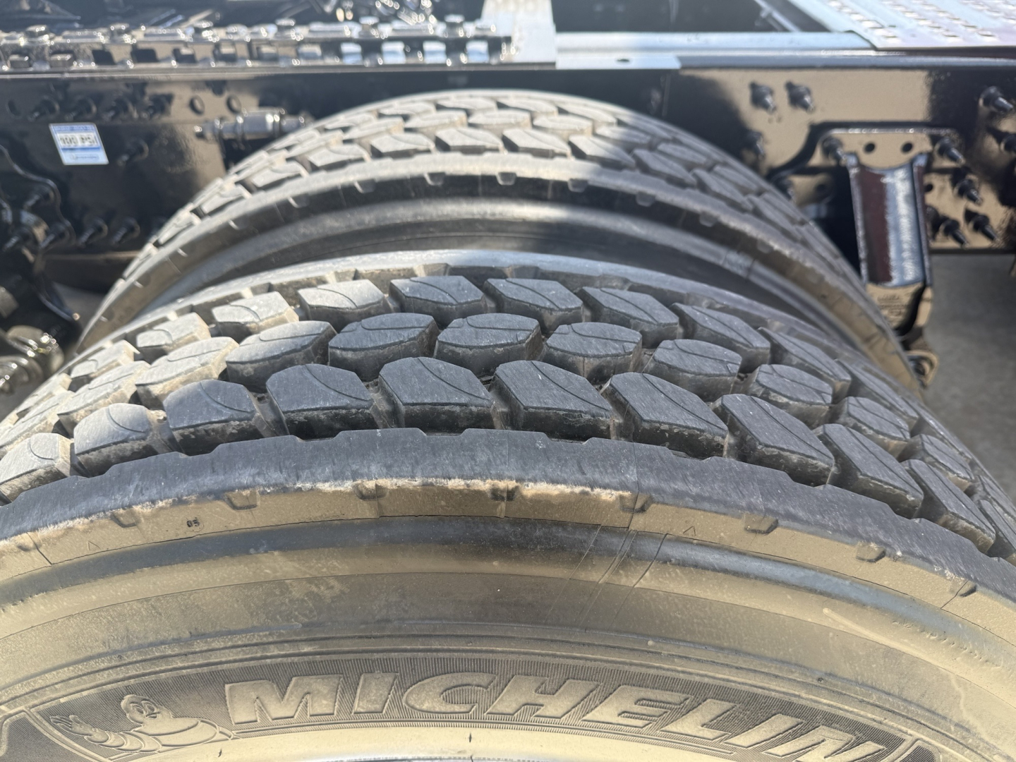 Rear dual tires on a Volvo VNL64T860 truck showing Michelin tire tread and wheel area.