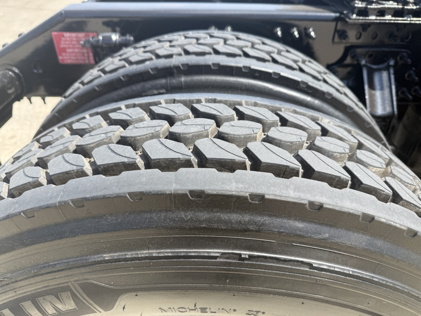 Rear view showing dual rear tires on a Volvo truck with tread pattern and rims visible.
