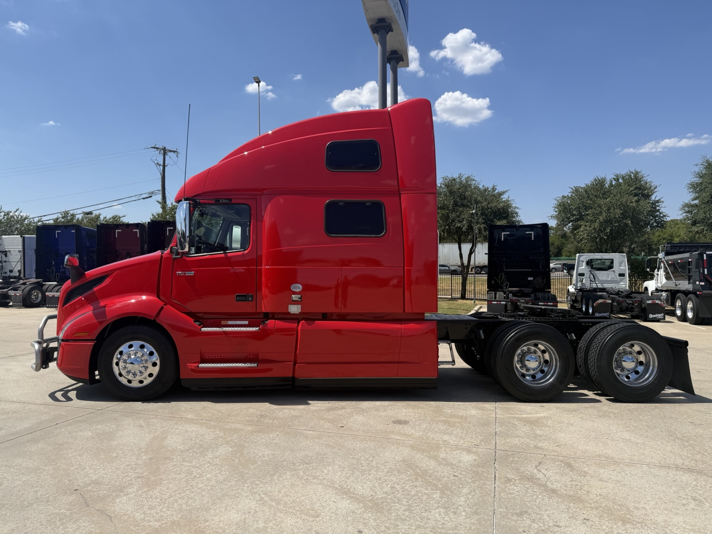 Volvo VNL64T860 sleeper tractor in red side profile view showing 6x4 drivetrain with chrome wheels and aerodynamic cab, no visible text on decals.