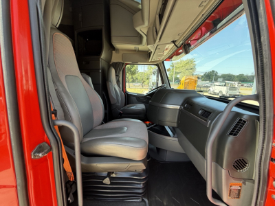 Interior cab view of a Volvo VNL64T860 sleeper tractor showing front seats and dashboard area.