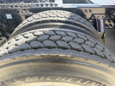 Rear dual tires on a Volvo VNL64T860 truck showing Michelin tire tread and wheel area.