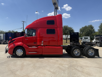 Volvo VNL64T860 sleeper tractor in red side profile view showing 6x4 drivetrain with chrome wheels and aerodynamic cab, no visible text on decals.