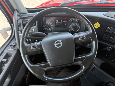 Volvo VNL64T860 steering wheel and dashboard view inside cab with steering wheel controls and instrument cluster.