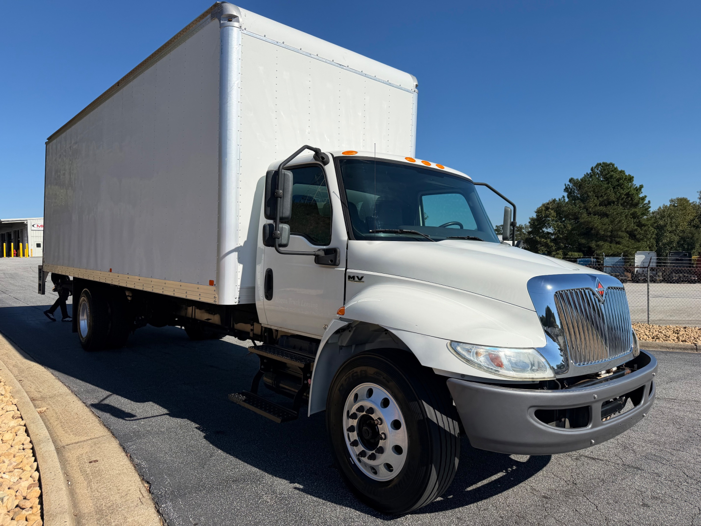 International MV-Series box truck with white cab and large box rear, VIN 3HAEUMML7NL681138 and stock tag 0633514 visible on listing page.