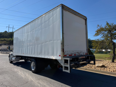 Box truck rear and side view showing large cargo box on International MV607 with liftgate at back.