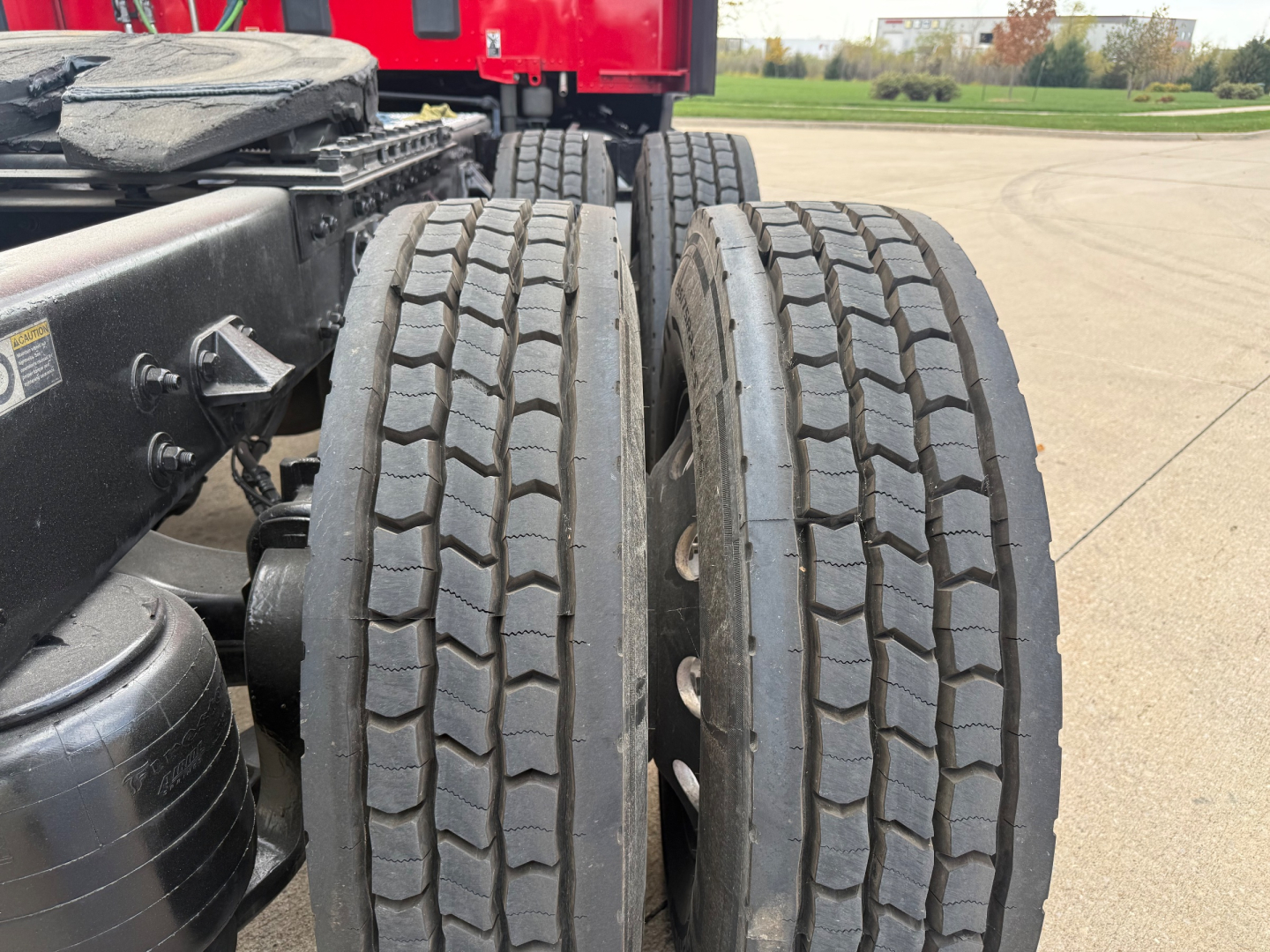 Kenworth T680 tractor chassis showing dual rear wheels and tire tread detail.