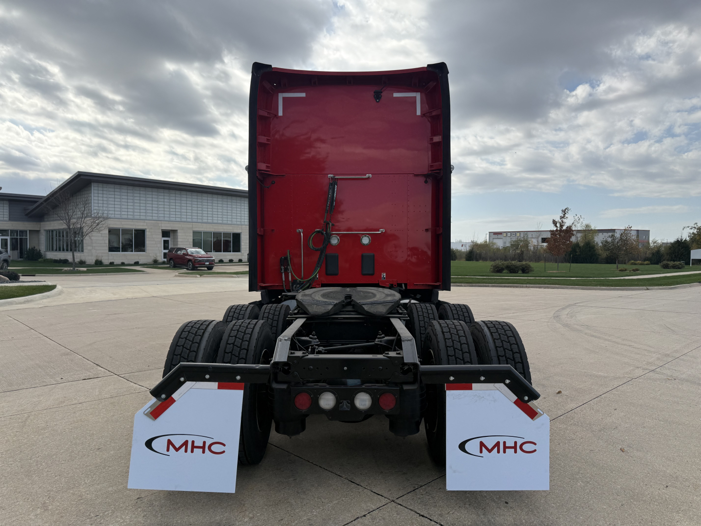 Kenworth T680 rear view showing fifth wheel and dual rear axles with MHC mudflaps.
